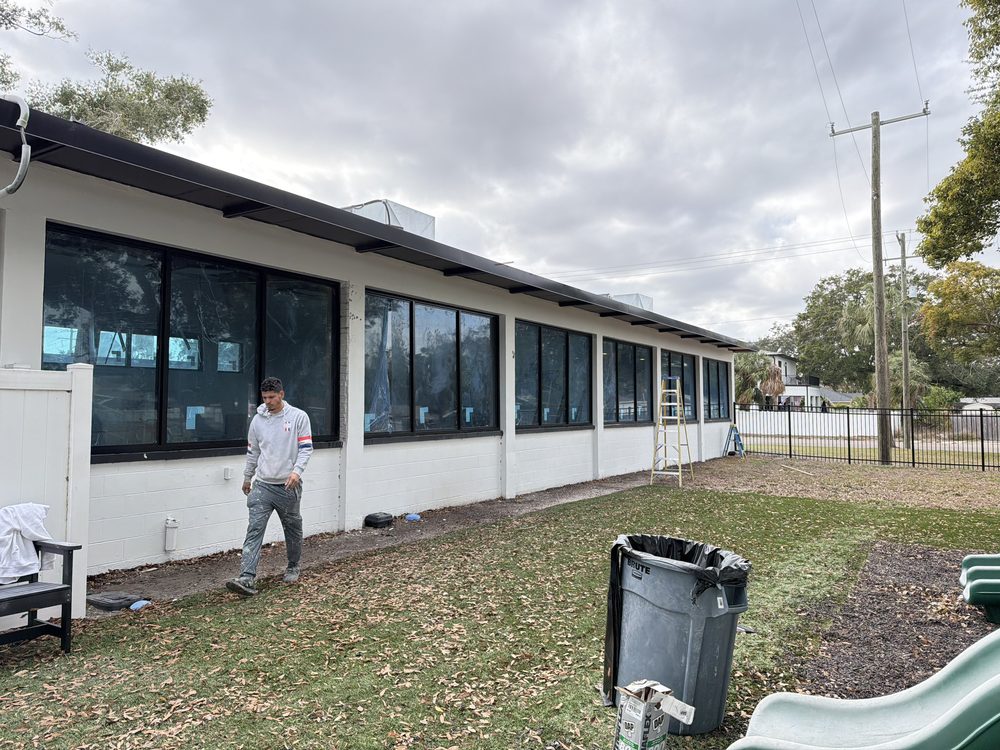 Ribbon of aluminum storefront windows along commercial exterior